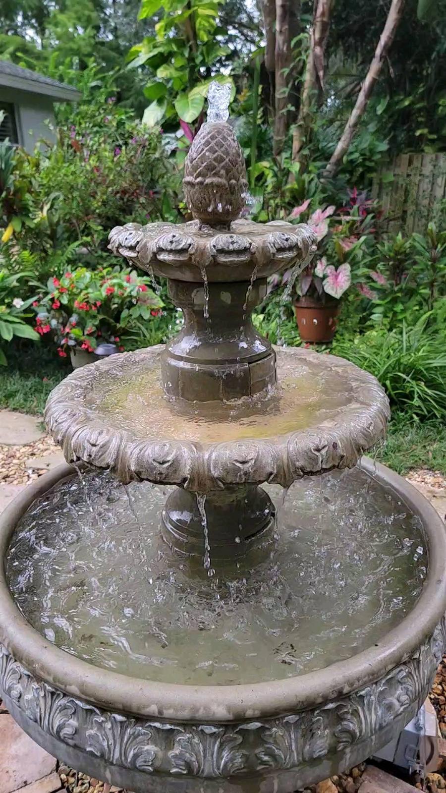 Restored tiered fountain with clear water cascading down stone tiers